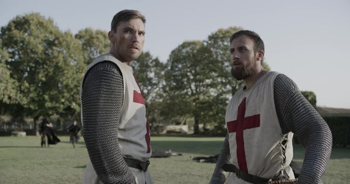 Two knights facing foes in grassy field