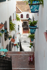 Small European tiny street with stairs in the old town of Mijas, Spain - 768353802