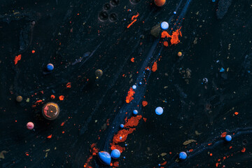 Amazing multi colored bubbles of paint on the oil surface.