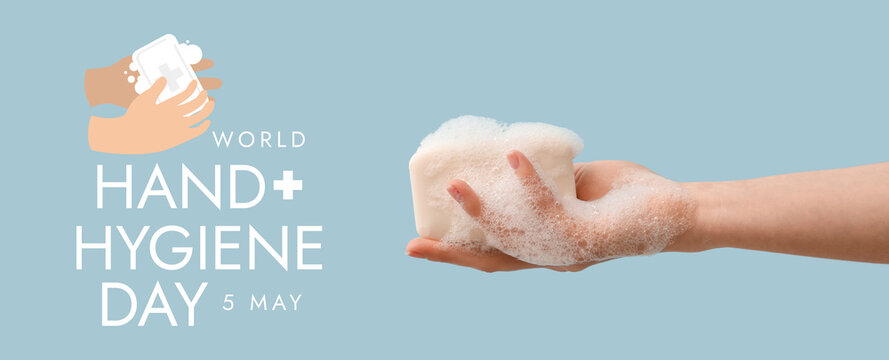 Hand with soap on light blue background