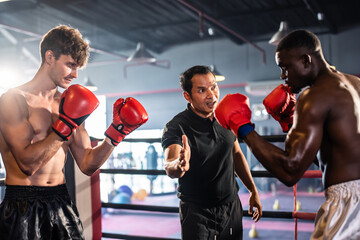 Two young professional boxer having a competition tournament on stage. 