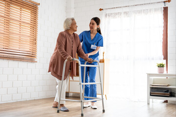 Asian senior older woman patient doing physical therapy with caregiver. 