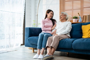 Asian lovely family, young daughter talking and sit with senior mother. 