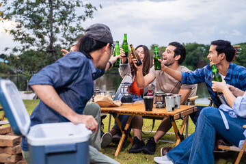Group of diverse friend having outdoors camping party together in tent. 