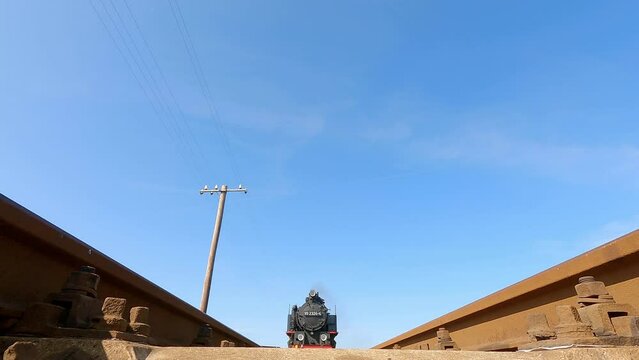 Steam narrow gauge train passing over the camera
