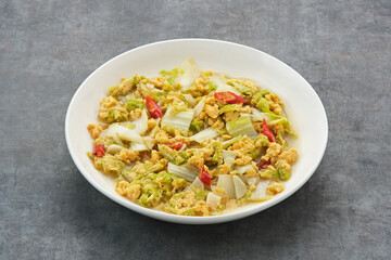 Tumis Sawi Telur or stir fry egg cabbage, Indonesian food
