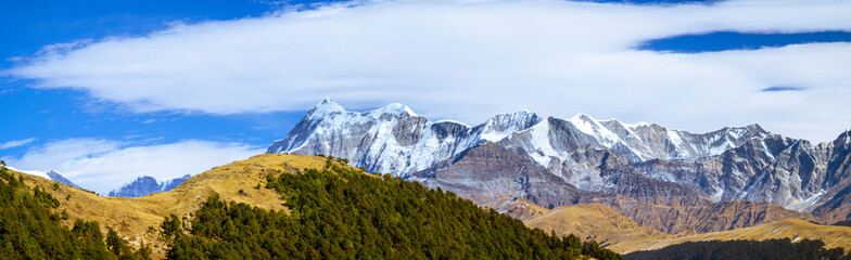  Panoramic landscape with sky.  Scenic mystic view of Himalayan peaks such as Mt. Trishul, Mt Nanda...
