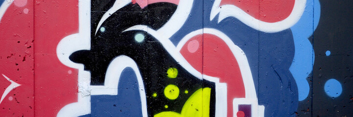 Colorful background of graffiti painting artwork with bright aerosol outlines on wall. Old school...