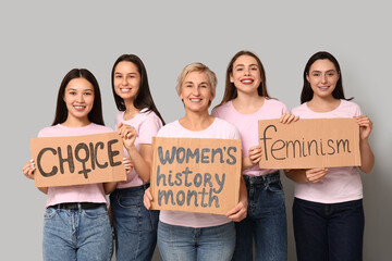 Portrait of beautiful women with different slogans on grey background. Women history month