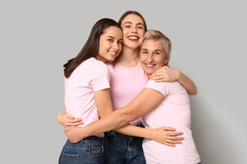 Fototapeta premium Portrait of hugging women on grey background. Women history month