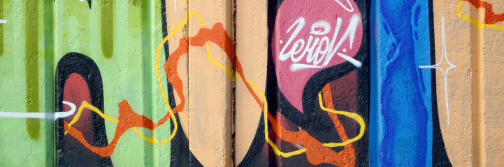 Colorful background of graffiti painting artwork with bright aerosol outlines on wall. Old school street art piece made with aerosol spray paint cans. Contemporary youth culture backdrop