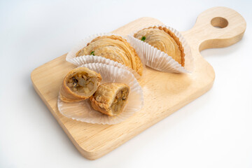 Chicken Curry puff on wooden plate on white background, Curry puff pastry on white background.