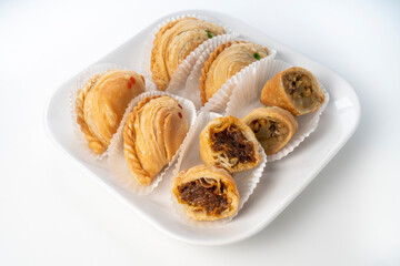 Chicken Curry puff on black plate on white background, Curry puff pastry on white background.
