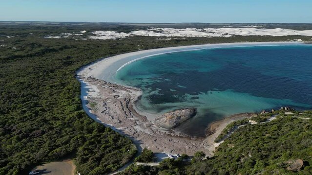 Beautiful Wylie Bay Rock Beach in Western Australia with clear water and coral reef. Green Island and rocky shore. Drone wide shot.