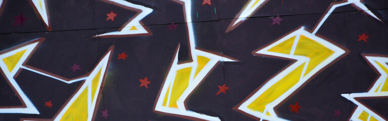 Colorful background of graffiti painting artwork with bright aerosol outlines on wall. Old school...