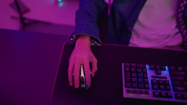 Close up of young Esport male gamer play online video game on computer. 