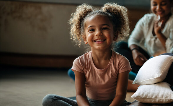 a little toddler, a girl doing yoga or dance or ballet, fun and joy, a smile on the little girls face, black or african american, cute child