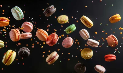 Foto op Canvas Colorful cake macarons and colorful almond cookies falling isolated on a dark background © PrettyStock