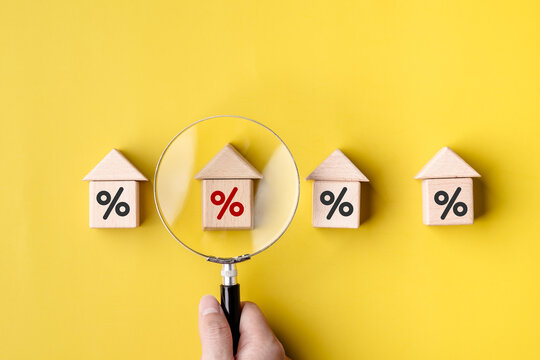 Women customer use magnifying glass finding to interest rate home is minimum, affordable alternative price, economic recession, .reduce costs, mortgage home, financial and investment concepts.