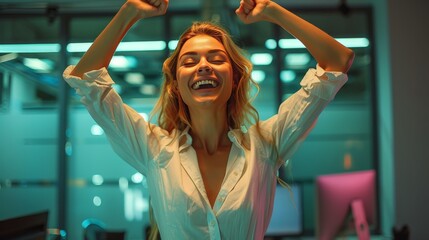 businesswoman celebrating success while standing at her workstation