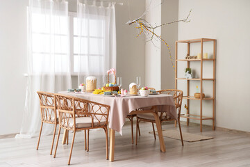 Beautiful table setting for Easter cakes and eggs in dining room