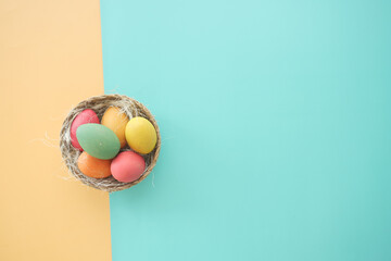 easter concept with multi color egg on pink background.