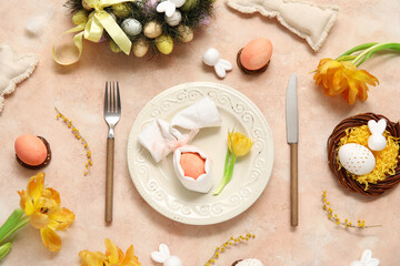Table setting with Easter eggs, beautiful tulips and mimosa flowers on beige background