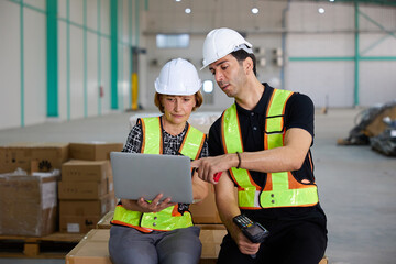 workers working on laptop computer in the warehouse storage