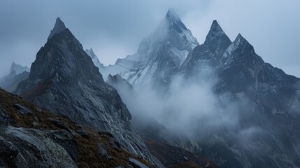 Jagged peaks disappear into the mist as the heavy monsoon rains continue to batter the rugged terrain. - obrazy, fototapety, plakaty