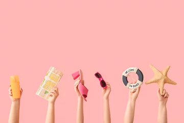Zelfklevend Fotobehang Female hands with starfish, sunglasses, sunscreen, map,  decorative lifebuoy and heeled sandal on pink background. Travel concept. © Pixel-Shot