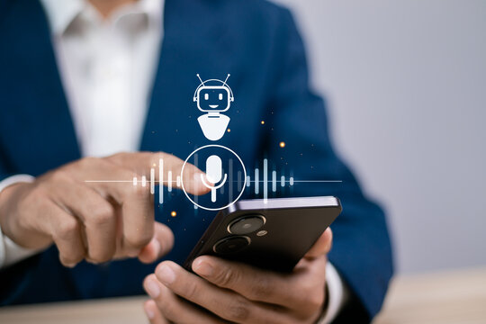 Voice Recording and Use AI Enabled Internet Search for Easy Access to Information.  Businessman using smartphone with voice icon on virtual screen for conversation with AI chatbot.