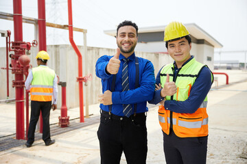 worker and businessman smiling and thumbs up pose in the factory