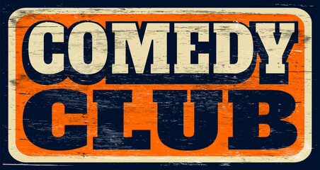 Aged and worn comedy club sign on wood