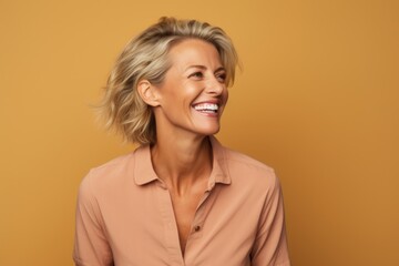 Cheerful mature woman with short blond hair. Portrait of happy mature woman looking at camera.