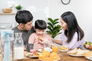 activities together during the holidays. Parents and children are having a meal together during the holidays. Mather prepare milk for son on morning, enjoy, weekend, vacant, family time, happy.