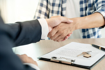 lease, rental and selling home. Dealership manager smile handshake to the new homeowner. rent...