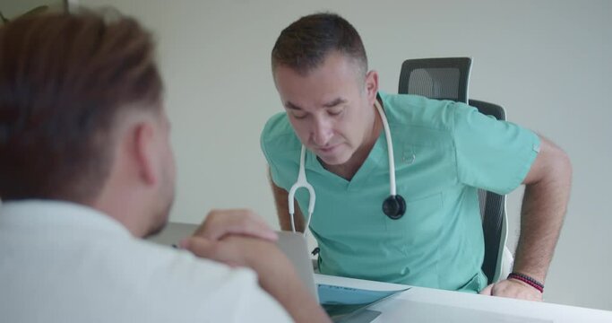 Male specialist is discussing with young, undisciplined patient who is not following the prescribed treatment. He tells him that the problem is not resolved and that he need to take it more seriously.