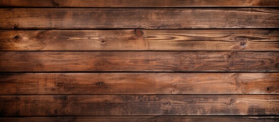 A close up of a brown hardwood wall made of rectangular wooden planks with a wood stain. The planks form a pattern resembling brick