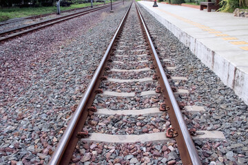 Straight railroad line with small stone on floor background