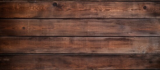 Wooden wall with a dark brown stain showing intricate patterns and textures for background or...