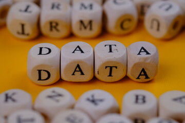 data word concept on wooden cubes blocks. On a yellow background. 