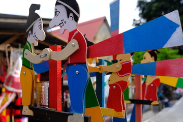 gareng and petruk puppet toys, made from wood. When a wind blows, it will round and round. 