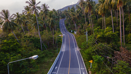 The coastal road passes through coconut plantations and then mountains of Nakhon Si Thammarat Province, Thailand.