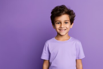 portrait of smiling little boy in purple t-shirt, isolated on violet