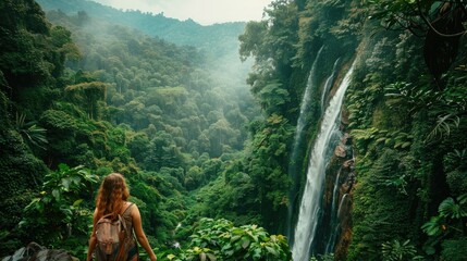 Adventure woman travelers exploring amazing hidden waterfall in forest