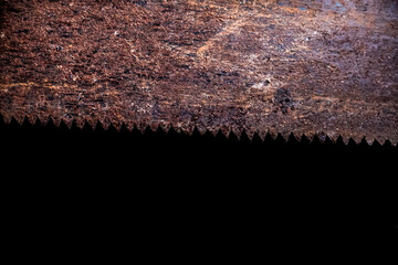 Close up the texture of a rusty saw, rusty hand saw blade isolated on black background