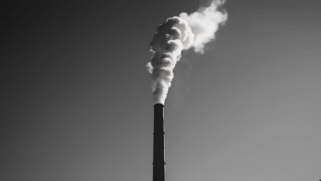 A black and white photograph of a lone smokestack rising into a clear blue sky. . AI generation.