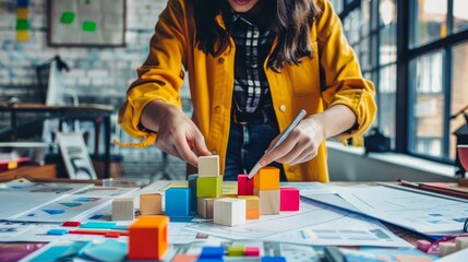 Fototapeta premium A woman is building a tower out of blocks