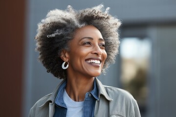 Portrait of a beautiful african american woman smiling outdoors. - Powered by Adobe