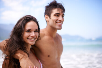 Beach, smile and couple with vacation, ocean and weekend break for honeymoon, embrace and adventure. Outdoor, seaside and travel with man or woman with holiday or love with anniversary, hug or summer